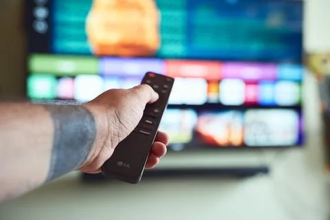TV time with remote. Stock Photos