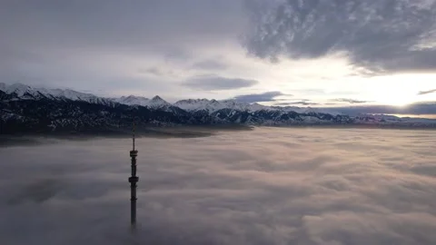 The TV tower looks out of the clouds at sunset. Stock-Footage 226090445