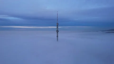 The TV tower looks out of the clouds at sunset. Video stock 226350076