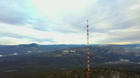 TV tower on the mountain among the winter pine forest Stock Footage 120397646