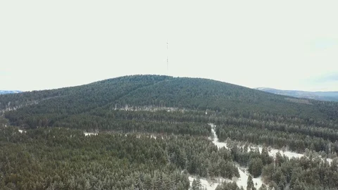 TV tower on the mountain among the winter pine forest Video stock 120400201
