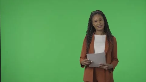 TV Weather Forecast Program. African American woman meteorologist pointing at Stock Footage 244941176