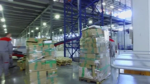 TVER - MAY 17, 2017: Worker moves car with stack of parcels in Ozon company Stock Footage 82682613