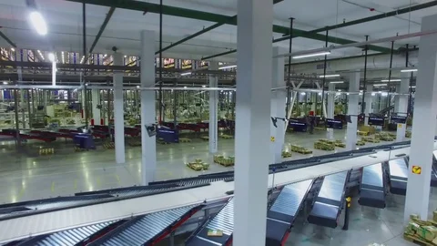 TVER - MAY 17, 2017: Worker takes parcels from conveyer and put in stack in Ozon Stock Footage 82682643
