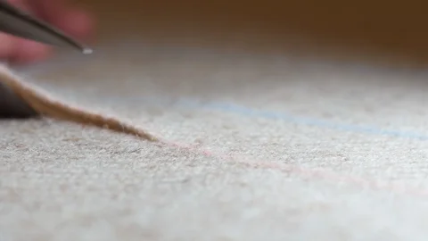 Tweed Tailoring at work, cut costume fabric with scissors according to drawn Stock Footage 128993534