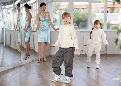 Tween boy mimicking comedic stroll of Charlie Chaplin during dance rehearsal Stock Photos