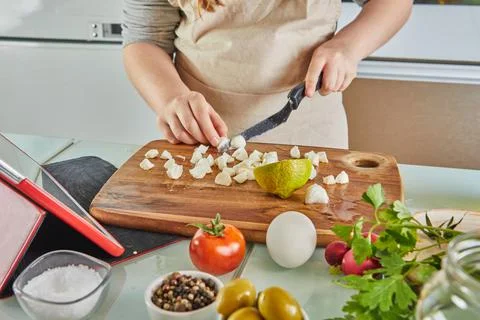 Tween cooking according the tutorial of online virtual master class, And look Stock Photos