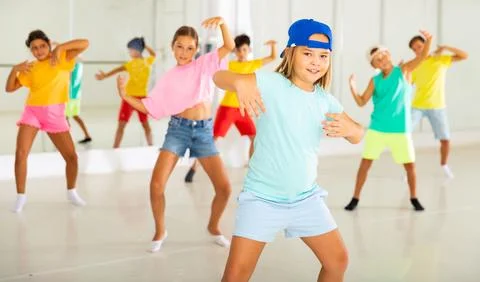 Tween girl breakdancer posing during group dance class Stock Photos