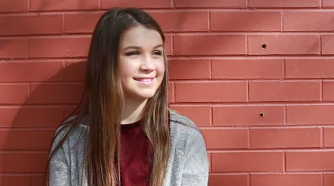 Tween looks off camera, laughing Stock Footage 61513701