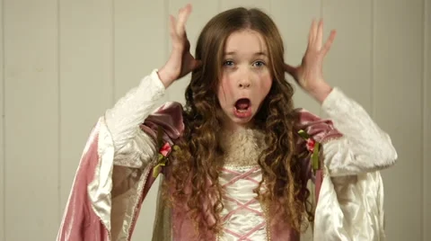 A tween princess pulls faces and sticks her tongue out at the camera Stock Footage 44116168