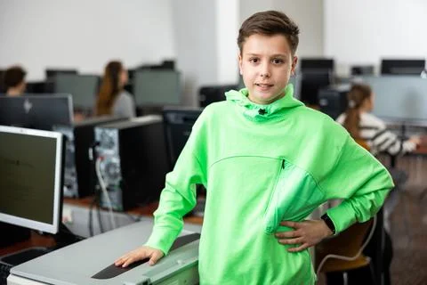 Tween schoolboy standing in computer class ready for lesson Stock Photos