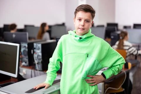 Tween schoolboy standing in computer class ready for lesson Stock Photos