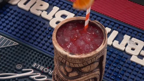 Tweezers adding orange slice on top of tropical cocktail 4K Stock Footage 196821436