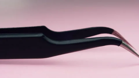 Tweezers on pink background macro. 4k detail close up Stock Footage 155284341
