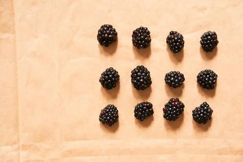 Twelve blackberries on a beige craft paper background, form of a rectangle Foto stock