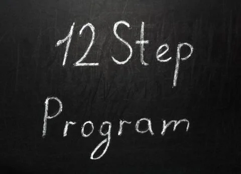 Twelve step program written in white chalk on a black chalkboard Illustrazione stock