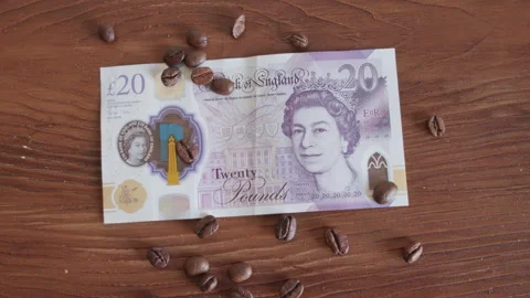 Twenty pound  on coffee beans in close-up Stock Footage 296639978