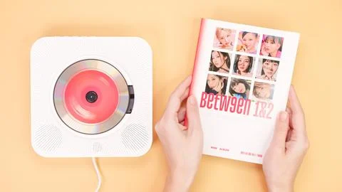 Twice Between 1 and 2 mini Album Box set on yellow. Red music disc in white c Stock Photos