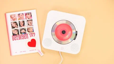 Twice Between 1 and 2 mini Album Box set on yellow. Red music disc in white.. Stock Photos