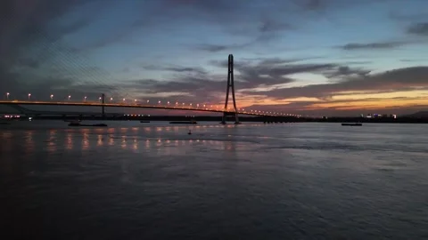Twilight aerial of bridge, river and city lights in China Stock Footage 337765424