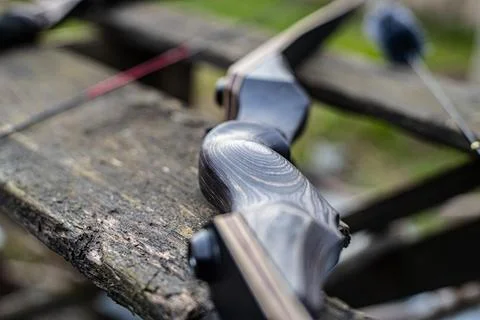 Twilight Archery: Close-Up of Bow on Rustic Wooden Stand Stock Photos