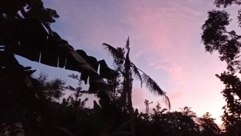 The twilight atmosphere of the setting sun illuminates the surrounding hills. Stock Footage 325833493