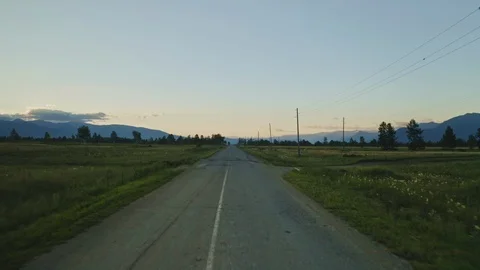 Twilight, birds eye panorama, empty road in the middle of spacious green valley Stock Footage 126365713