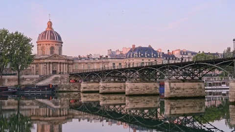 Twilight casts a soft glow on Pont des Arts as the Seine calmly flows beneath th Stock Footage 316953221