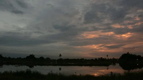 Twilight clouds over the fish pond in Thailand Stock Footage 83777277