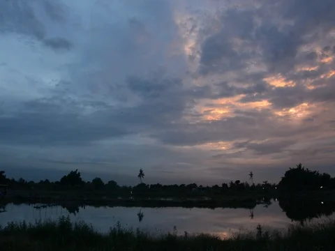 Twilight clouds over the fish pond in Thailand Stock Footage 83777294