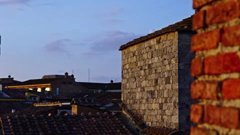 Twilight Colors over Ancient Rooftops and Stone Walls Stock Footage 256240572