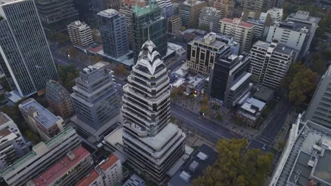 Twilight drone circle around tiered tower in Las Condes Santiago Chile Vídeos de archivo 334637199