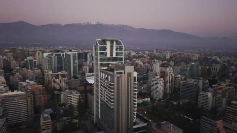 Twilight drone orbit beside modern Apoquindo office tower Santiago Chile Vídeos de archivo 334637358