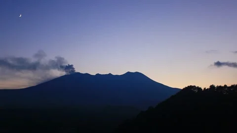 Twilight Eruption of Mount Ontake and the Earthshine Crescent Moon Stock Footage 330474540
