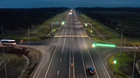 A twilight freeway, a stoplight, a multi-lane suburban highway. Aerial Panorama Stock Footage 257768930