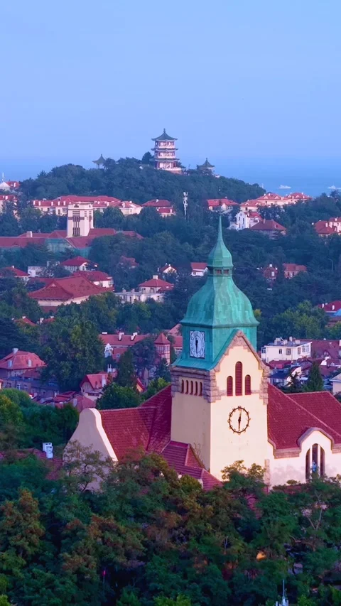 Twilight Glow Over Qingdao's Iconic Church and Hilltop Pagoda Stock Footage 330794300