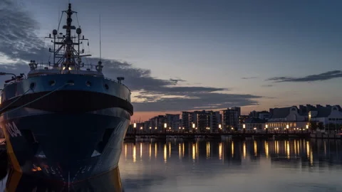 Twilight Harbor with Docked Ship and City Lights Stock Footage 303944642