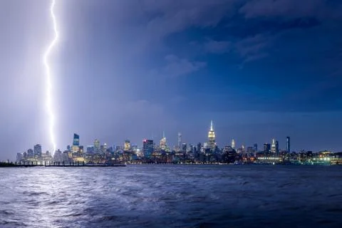 Twilight lightning strike in Midtown Manhattan, New York City skyscrapers Stock Photos