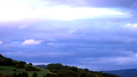Twilight over hilly landscape with a cloudy sky Stock Footage 134904041