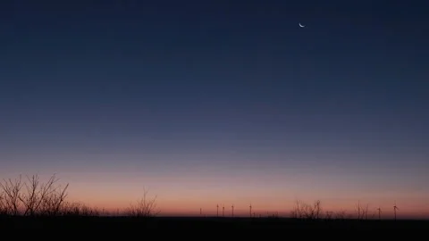 Twilight Over Wind Farm with Crescent Moon Stock Footage 282925584