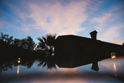 Twilight Reflection of House and Trees in Water Stock Photos