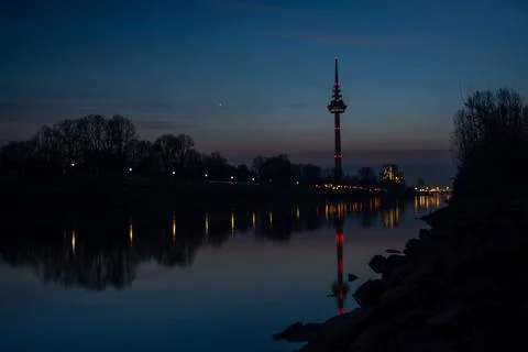 Twilight reflection of a tower in a calm river Foto stock
