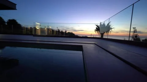 Twilight Reflections: Infinity Pool Sunset Glow Video stock 310237599