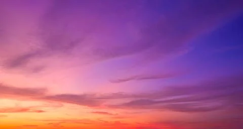 Twilight sky background with sunset clouds on colorful evening horizon sky Stock Photos
