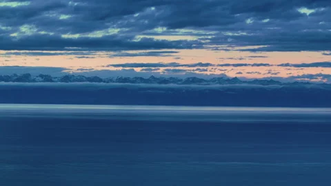 Twilight Sky over Issyk Kul Lake and Snowy Mountains Kyrgyzstan Stock Footage 325650498