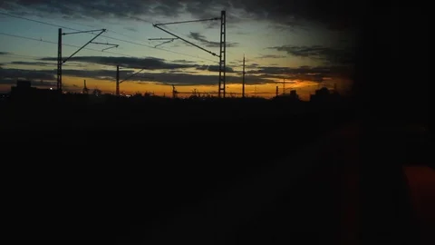 Twilight Sky shown from a slowly moving train window near train station 库存影片 123406314