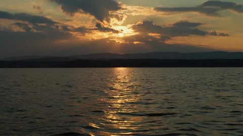 Twilight sunset on the lake. Cloudy sky, sunlight. Video stock 283082357