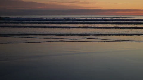 Twilight Surf Lines Rolling Onto Smooth Reflective Beach Stock Footage 340574694