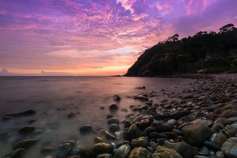 A twilight time after sunset on beach with stone foreground Stock Photos