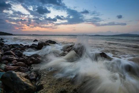 A twilight time after sunset on beach with stone foreground Stock Photos